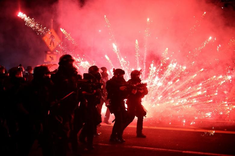 Police advance on protesters to clear a street on the 100th consecutive night of protests against police violence and racial inequality, in Portland, Oregon. REUTERS/Carlos Barria